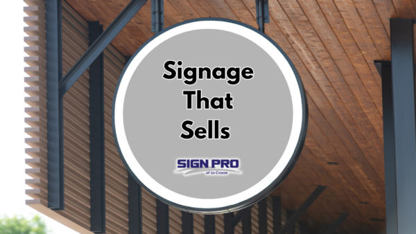 Sign Pro circular storefront signage with text "Signage that Sells".